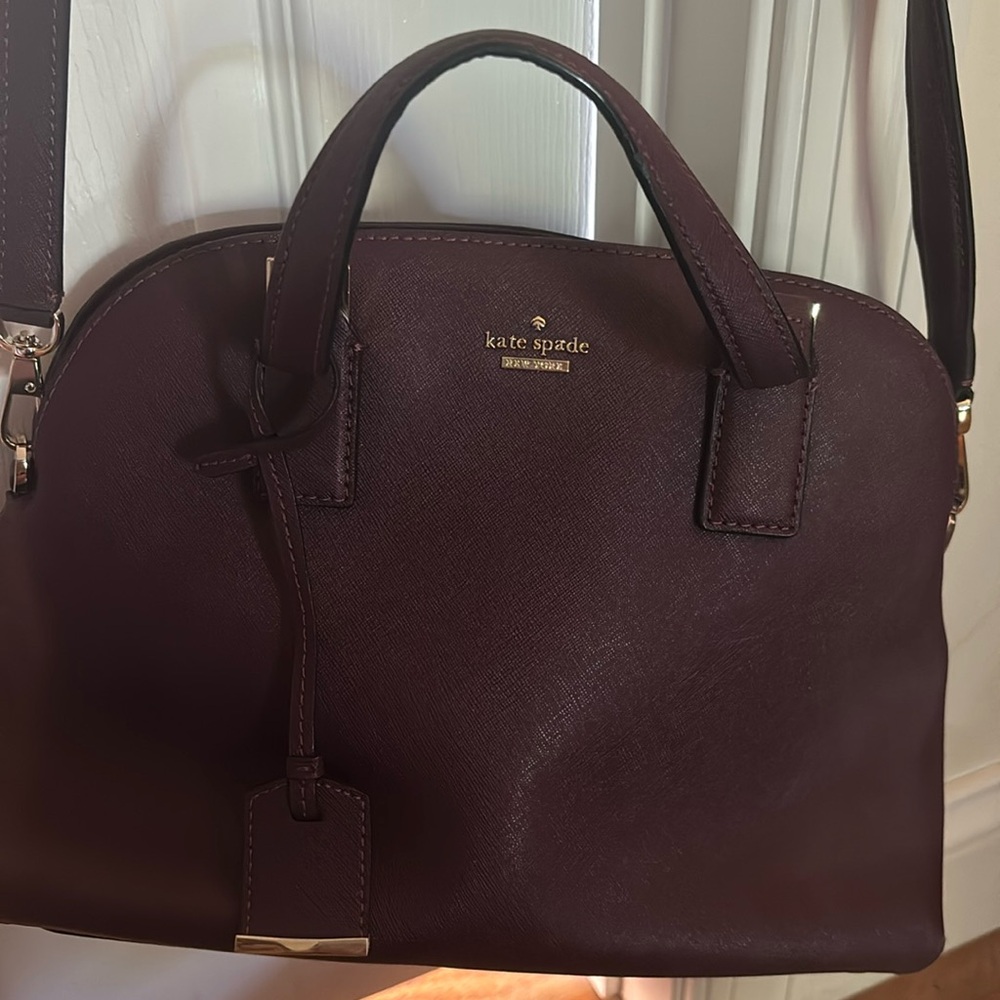 Kate Spade purple hand bag with shoulder bag strap.